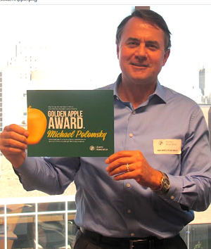 Dr. Polomsky holding Golden Apple certificate