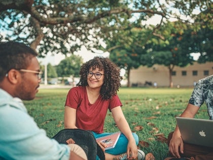 students sitting outside